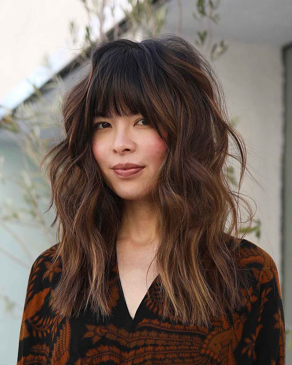 long shaggy brown hair with voluminous bangs